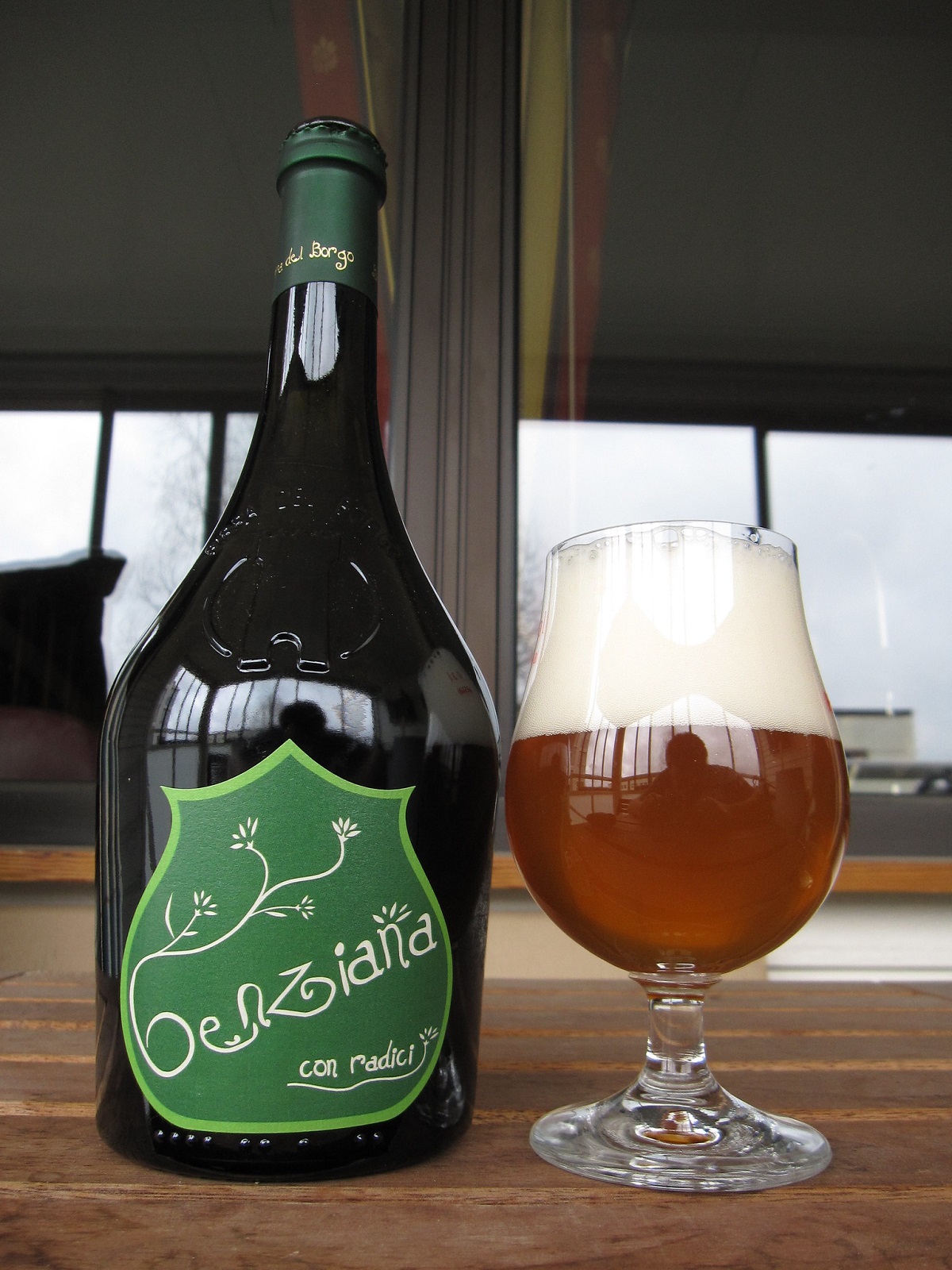 Verter una botella grande de cerveza, así como un vaso de cerveza
