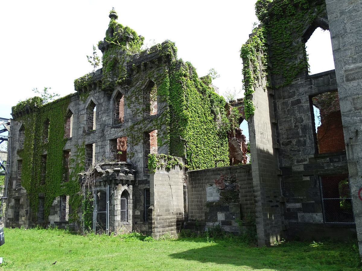 Un antiguo edificio de piedra ahuecado con hiedra trepando sobre él
