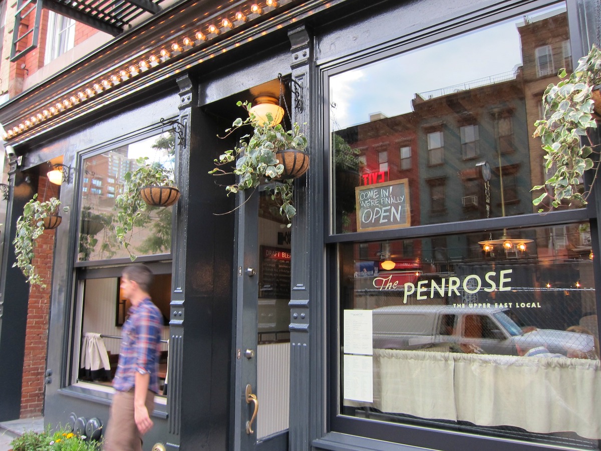 Exterior del restaurante The Penrose en el Upper East Side de Nueva York, con grandes ventanales