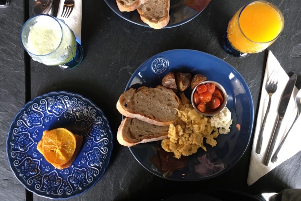 Un plato de pan, huevos y tomates cherry en Cais na Preguiça, un restaurante de visita obligada en Alfama