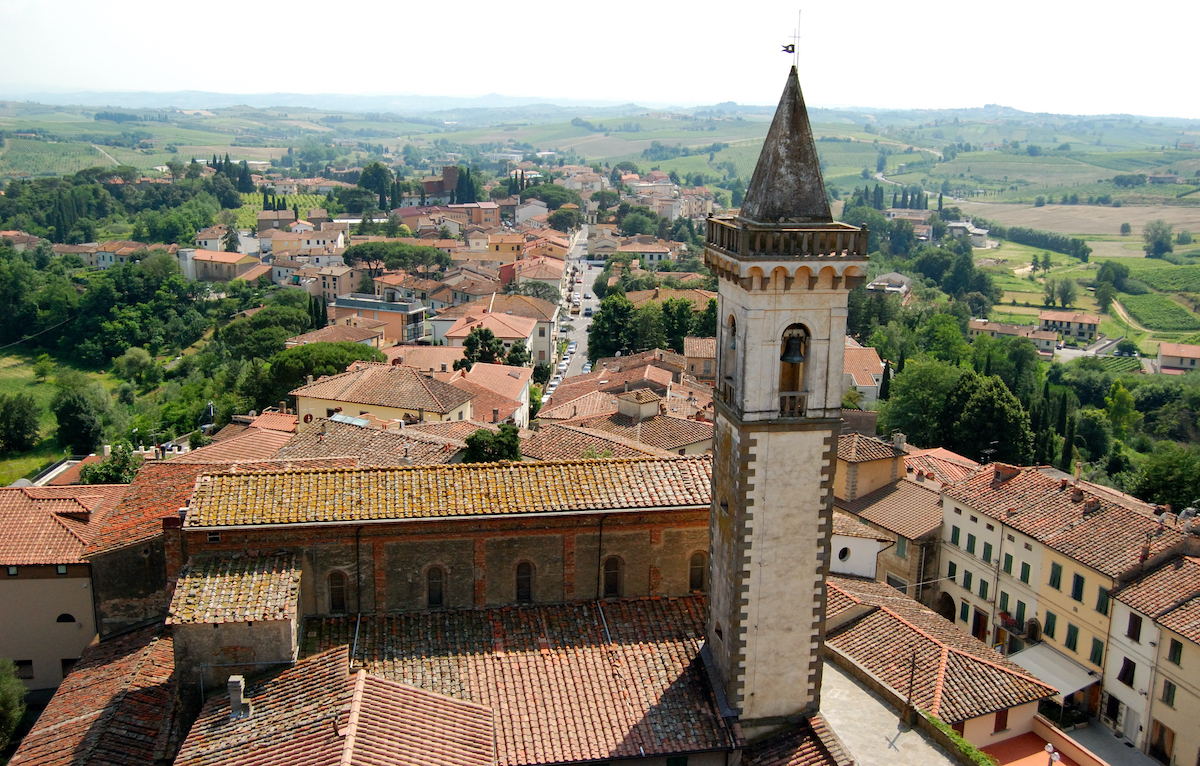 Una vista aérea de la ciudad de Vinci, Italia, con un campanario en primer plano.